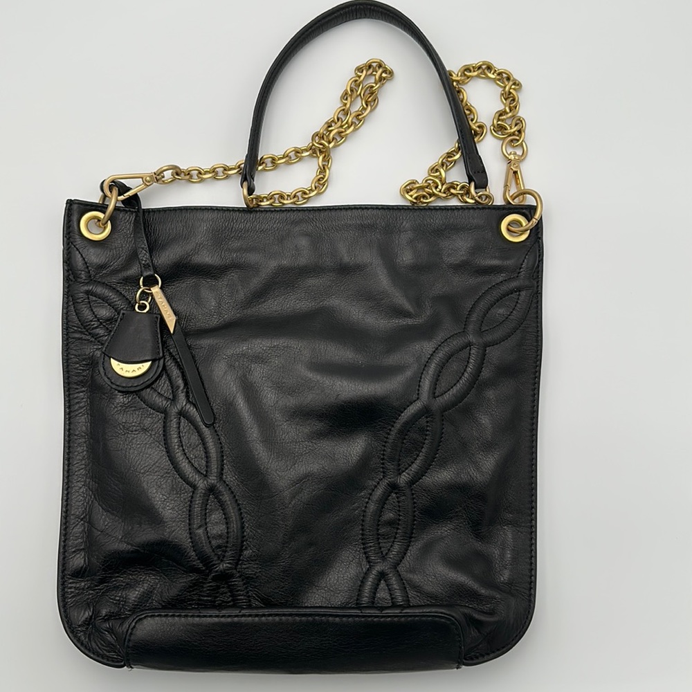 Black leather with gold chain. Cross body strap with chain link and leather.